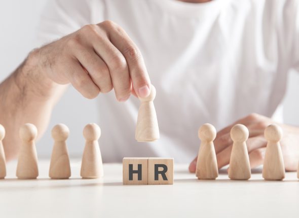 man-holding-wooden-human-figure